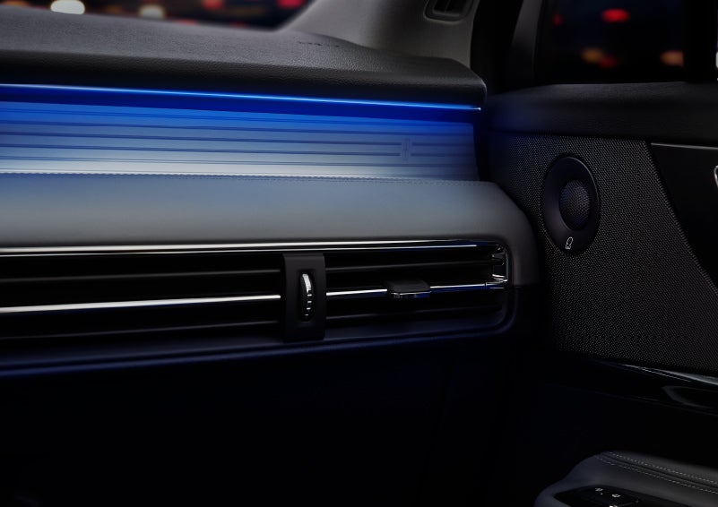A thin available ambient blue lighting illuminates the pinstripe aluminum under an ebony dashboard, emitting a cool energy | Covert Lincoln Austin in Austin TX