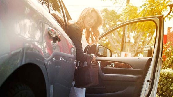 Lady getting out of a Lincoln car