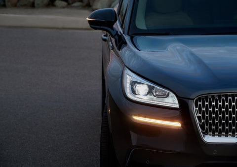 The turn signal on the front fascia is a bold sunset orange stroke of brilliance against a Flight Blue exterior | Covert Lincoln Austin in Austin TX