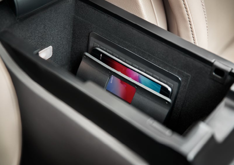 A smartphone device is securely tucked into the available wireless charging pad for an effortless energy boost | Covert Lincoln Austin in Austin TX