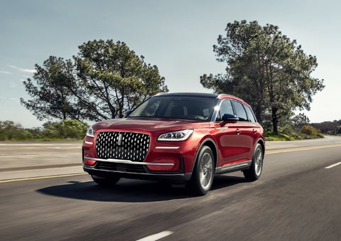 A 2024 Lincoln Corsair® SUV is shown being driven on a country road. | Covert Lincoln Austin in Austin TX