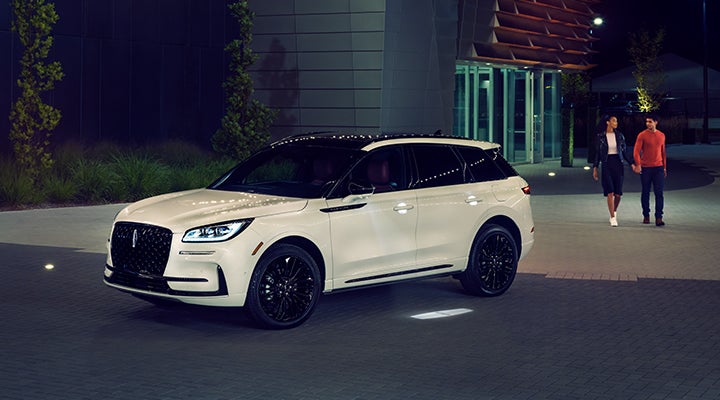 Two people approach a 2024 Lincoln Corsair® SUV featuring the available Jet Appearance Package. | Covert Lincoln Austin in Austin TX