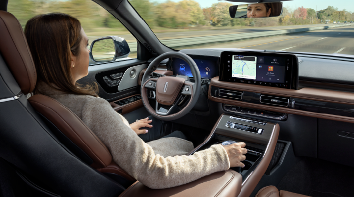 A woman is seen sitting in the driver’s seat of her 2025 Lincoln Aviator® SUV with her hands off the steering wheel. | Covert Lincoln Austin in Austin TX
