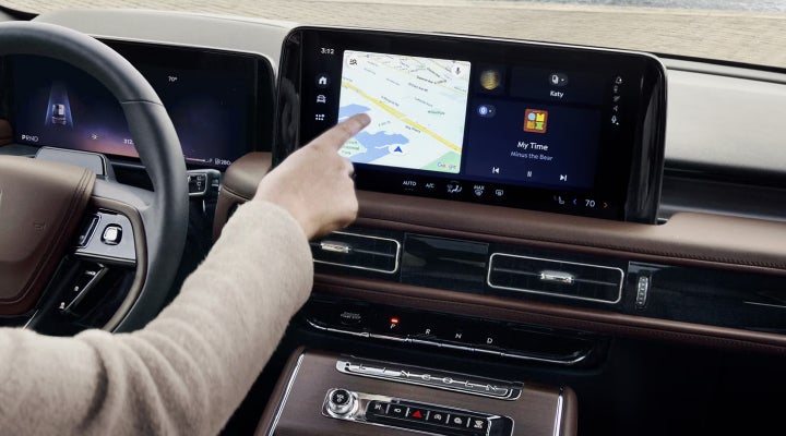 A person is tapping the center display touchscreen of a 2026 Lincoln Aviator® SUV. | Covert Lincoln Austin in Austin TX