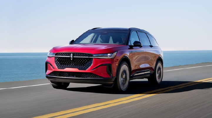 A 2026 Lincoln Nautilus® SUV is being driven on a seaside roadway. | Covert Lincoln Austin in Austin TX