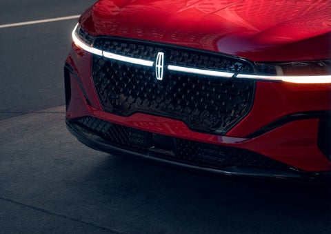 The available front LED light bar and center Lincoln Star logo glow at dusk. | Covert Lincoln Austin in Austin TX