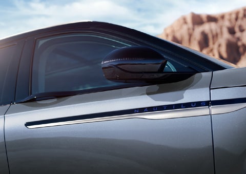 Blue lettering on the side of the vehicle that reads Nautilus indicates the available Hybrid Powertrain. | Covert Lincoln Austin in Austin TX