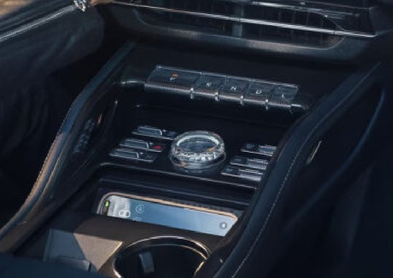 A smartphone is shown charging in the wireless charging pad. | Covert Lincoln Austin in Austin TX