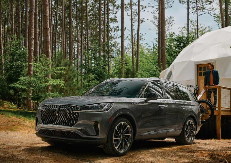 A 2027 Lincoln Aviator® is parked next to a high end glamping site. | Covert Lincoln Austin in Austin TX