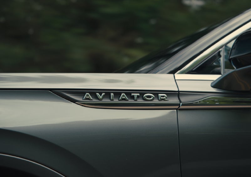 The driver’s side door and fender badging of a gray 2027 Lincoln Aviator® SUV are showcased. | Covert Lincoln Austin in Austin TX