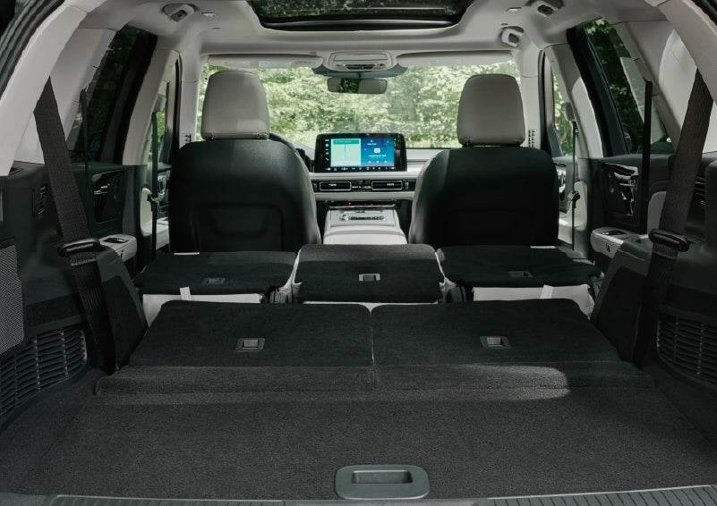 A rear to front view of the interior of a 2027 Lincoln Aviator® Black Label™ SUV shows the third and second rows folded flat | Covert Lincoln Austin in Austin TX