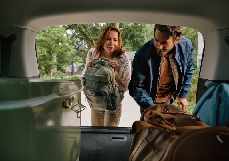 A couple loads luggage into the rear of a 2027 Lincoln Aviator® Black Label™ SUV..e 202 | Covert Lincoln Austin in Austin TX