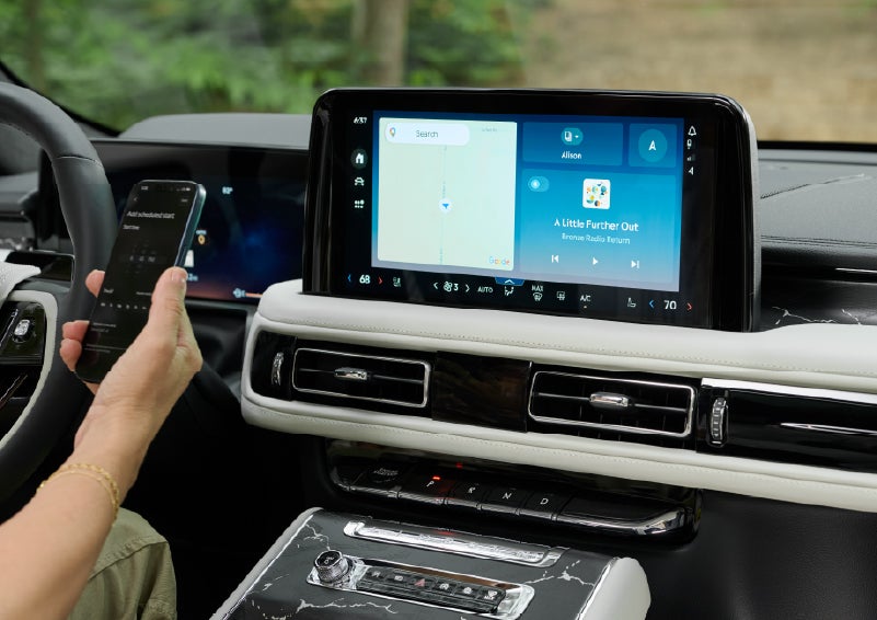 A person pairs thier phone with the center touchscreen of a 2027 Lincoln Aviator® Black Label™ SUV | Covert Lincoln Austin in Austin TX