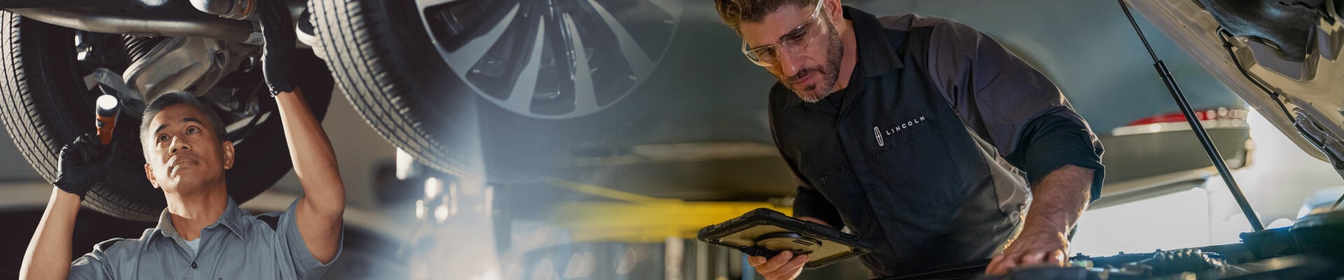 A Lincoln technician inspects under a vehicle with a flashlight. Another checks under the hood of a Lincoln.