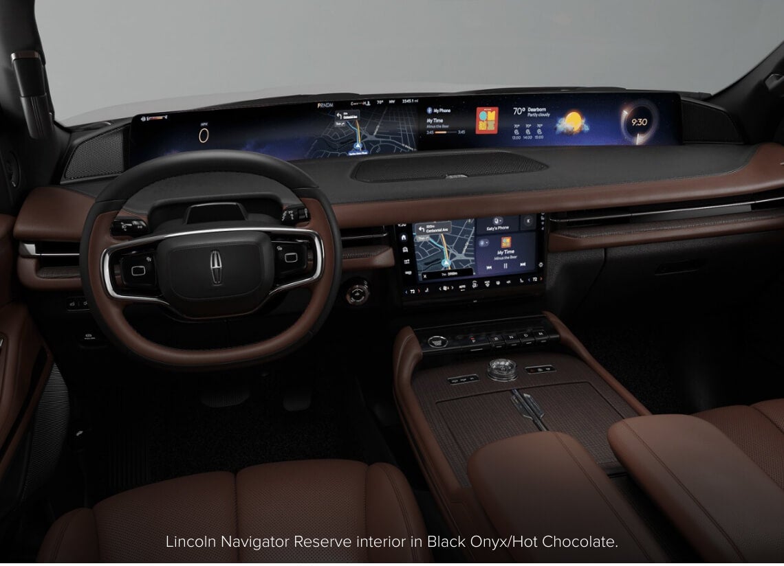 Interior dashboard view of a Lincoln Navigator Reserve in Black Onyx and Hot Chocolate displaying dual screens.