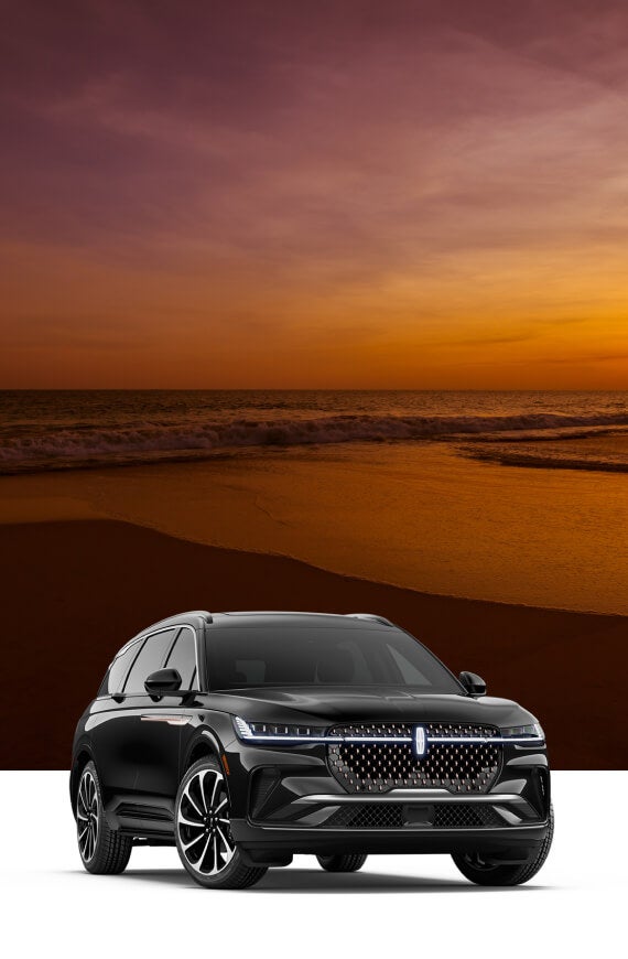 Front three-quarter view of a black Lincoln Nautilus Black Label with a golden beach sunset backdrop overlay.
