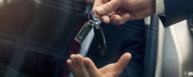 Driver being handed Lincon vehicle keys